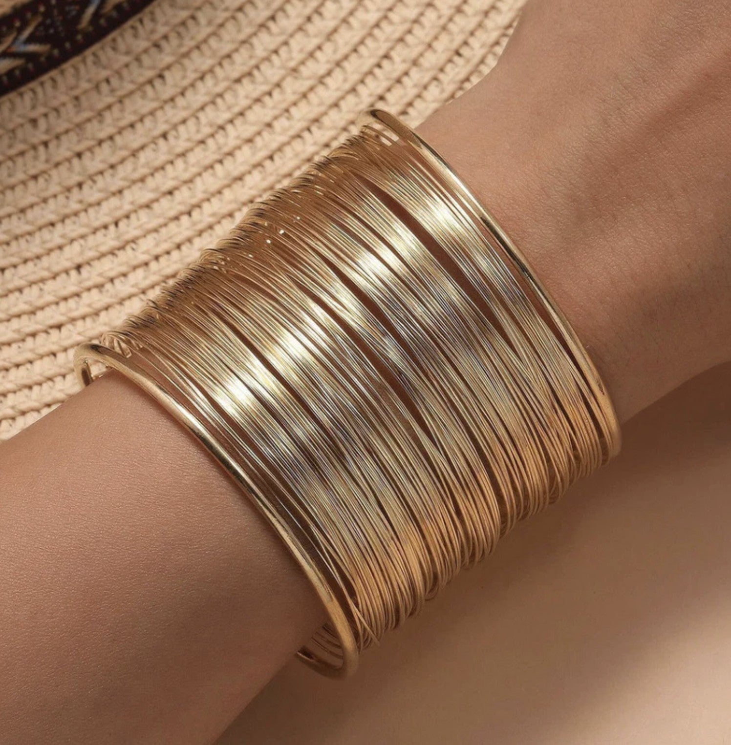 gold stacked wire cuff bracelet for women.
statement gold bangle with layered look.
bold gold open cuff bracelet for girls.
multi-layer gold-plated fashion bracelet.