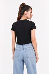 Person wearing a black t-shirt and light blue jeans on a white.black crop top, black crop top women, women's black crop top, black top for women, trendy black crop top, stylish black crop top, casual black crop top, fitted crop top, cropped top women, sleeveless black top, black fashion top, women's fashion top, ladies black top, black crop tank top, summer crop top, trendy women's clothing, casual women's wear, street style outfit, black crop top outfit, blue jeans outfit.gym top.