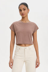 Woman wearing a brown cropped t-shirt and white pants on a plain background. brown cotton crop top. aesthetic fashion top. Comfortable cotton crop top in latte brown shade.Basic brown crop top for casual and layered outfits. Trendy brown cotton crop top for women’s fashion store. Soft stretch cotton brown crop top for daily wear. Brown fitted crop top with clean minimal design. Cotton cap sleeve crop top in earthy brown tone.
Women’s latte brown cropped cotton t-shirt top. Casual chic brown cotton crop top