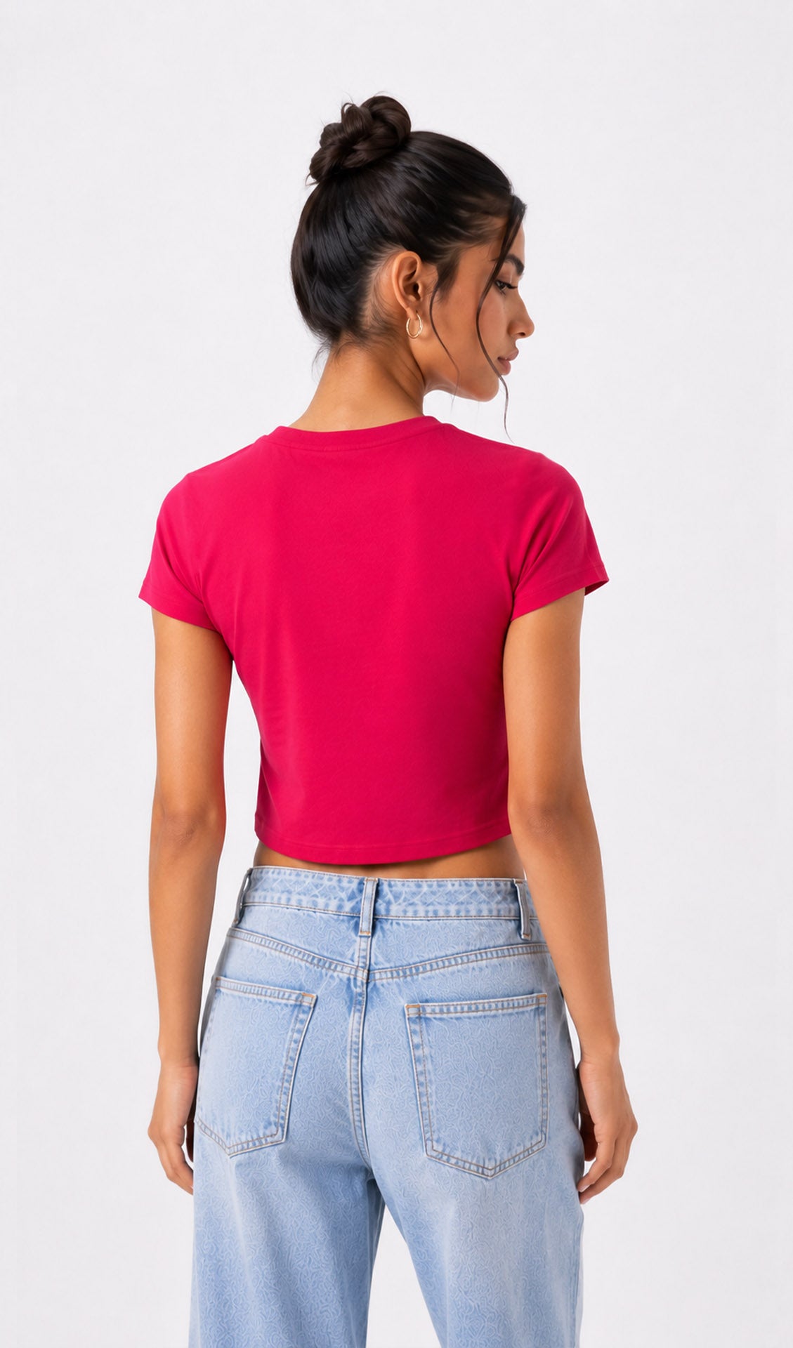 Person wearing a bright pink crop top and light blue jeans on a white background.pink crop top, hot pink crop top, women's crop top, pink top for women, trendy crop top, fashion crop top, summer crop top, casual crop top, stylish pink top, crop top outfit, women's fashion top, trendy women's top, college outfit ideas, casual fashion for women, ripped jeans outfit, street style women, cute crop top, girls crop top, pink fashion top, modern crop top, chic crop top, fitted crop top, cropped tank top, women's c