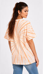 Woman wearing a tie-dye shirt and ripped jeans on a white background.Tie & dye t-shirt, women t-shirt, cotton t-shirt, casual outfit, trending t-shirt, Slayink orange tie & dye t-shirt, Slayink women tie & dye t-shirt, orange tie dye t-shirt women, oversized t-shirt , cotton t-shirt for women, summer t-shirt women, college wear t-shirt for girls, beach wear t-shirt women, gym wear t-shirt women, trendy college wear, pastel top, women's workout t-shirt, gym t-shirt women, ladies top, cotton t-shirt, trendy