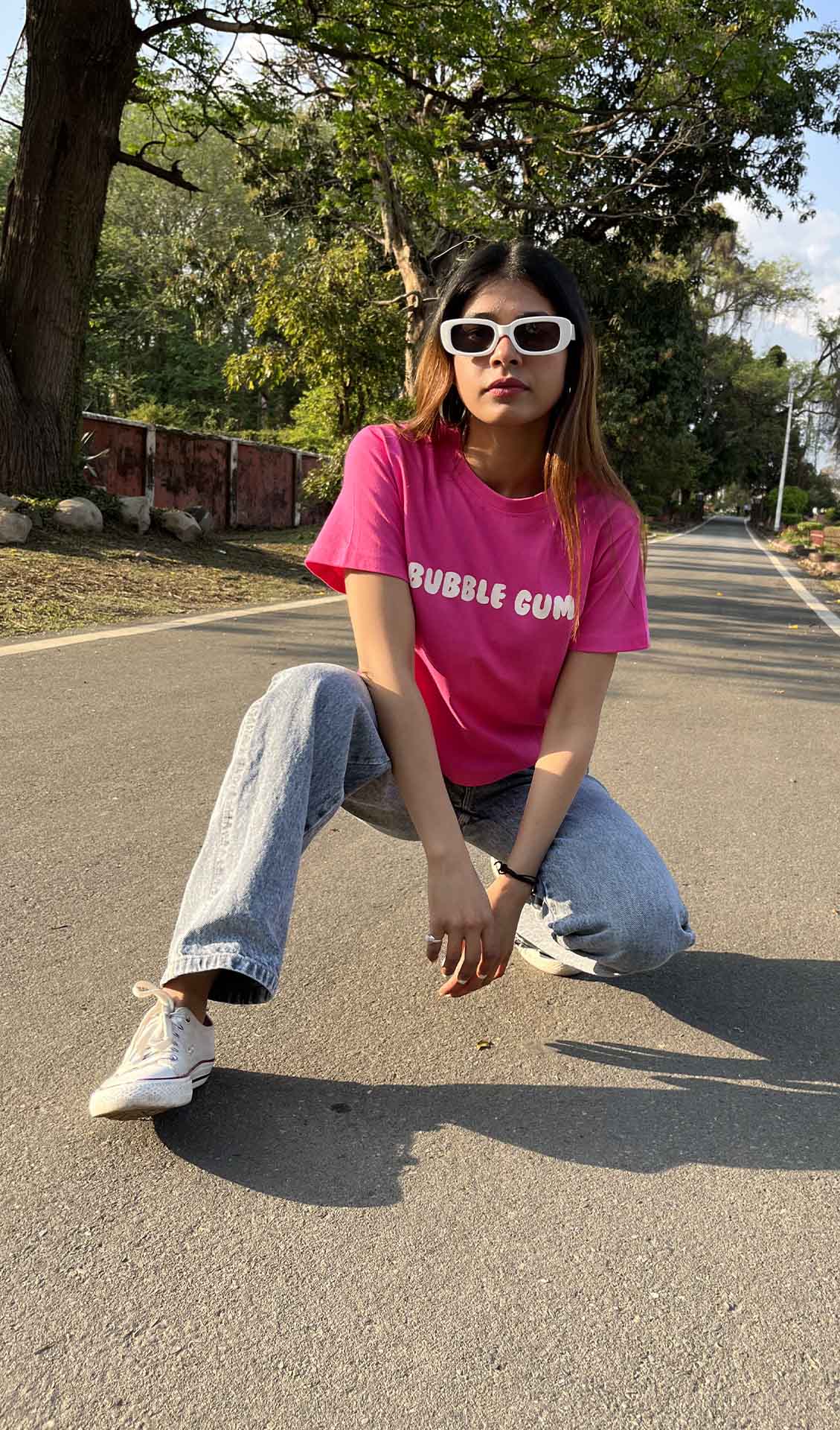 A woman wearing a bubble gum pink graphic t-shirt and sunglasses.A woman wearing a bubble gum pink graphic t-shirt and sunglasses, standing against a blue sky.pink graphic t-shirt for women, women's graphic tee, 100% cotton t-shirt, cotton t-shirt women,casual t-shirt for women
regular fit t-shirt women, printed t-shirt women, cute graphic tee, aesthetic t-shirt women, Korean aesthetic clothing
streetwear t-shirt women, everyday cotton tee, summer t-shirt women, trendy graphic t-shirt, college outfit women,