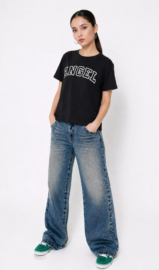 Person wearing a black t-shirt with 'ANGEL' text and blue jeans on a white background,Slayink Women  Angel Graphic black tshirt,black t-shirt women, printed t-shirt women, graphic print black tee. casual wear, cute gahic tshirt , black top, loose tshirt womens,  womens print tshirt, printed gym t-shirt women, college wear tshirt, relaxed fit t-shirt , women workout tshirt