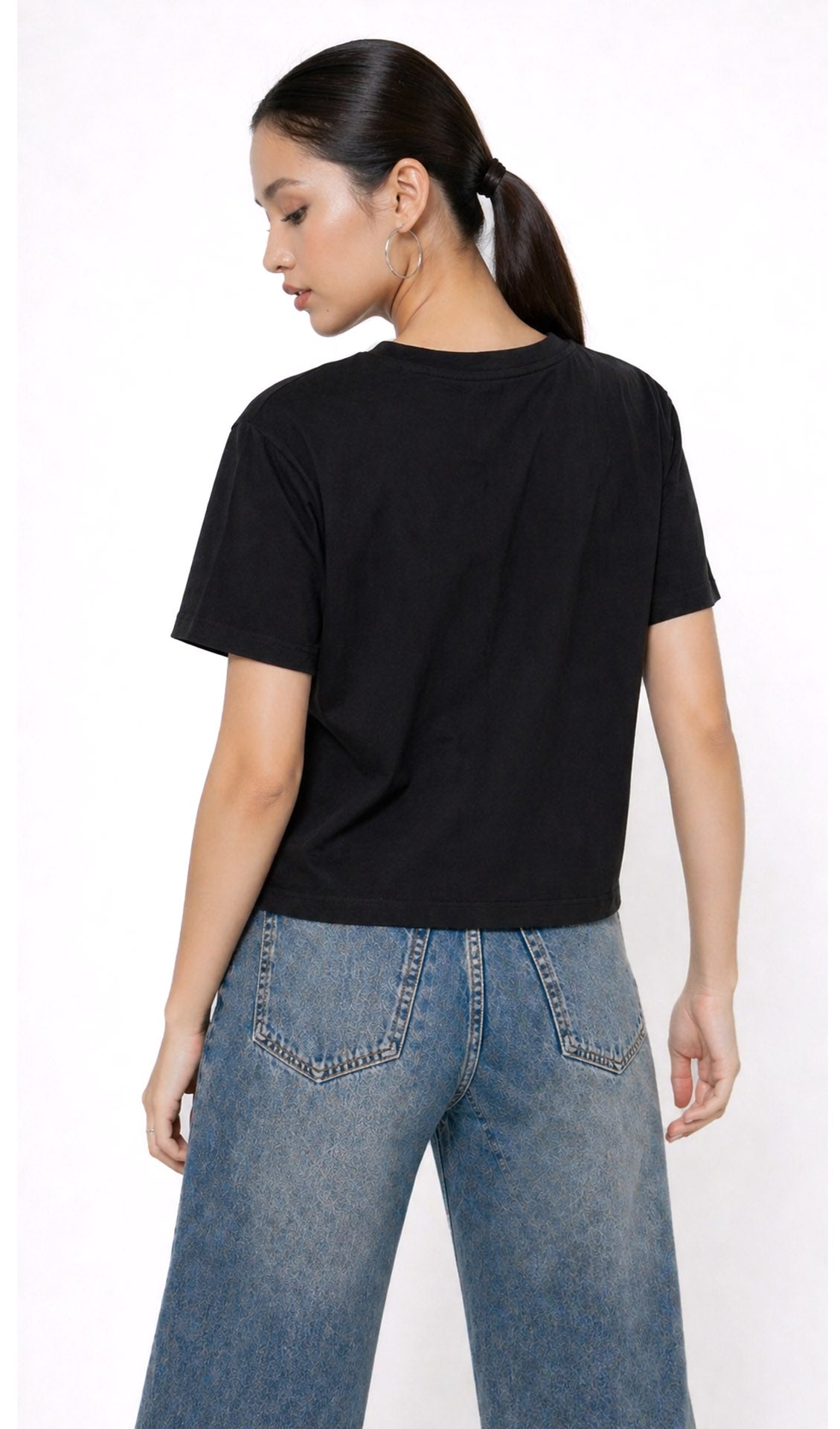 Person wearing a black t-shirt with 'ANGEL' text and blue jeans on a white background,Slayink Women  Angel Graphic black tshirt,black t-shirt women, printed t-shirt women, graphic print black tee. casual wear, cute gahic tshirt , black top, loose tshirt womens,  womens print tshirt, printed gym t-shirt women, college wear tshirt, relaxed fit t-shirt , women workout tshirt