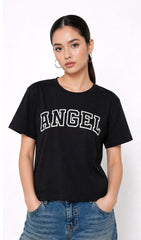 Person wearing a black t-shirt with 'ANGEL' text and blue jeans on a white background,Slayink Women  Angel Graphic black tshirt,black t-shirt women, printed t-shirt women, graphic print black tee. casual wear, cute gahic tshirt , black top, loose tshirt womens,  womens print tshirt, printed gym t-shirt women, college wear tshirt, relaxed fit t-shirt , women workout tshirt