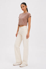 Woman wearing a brown crop top and white jeans on a white background. brown cotton crop top. aesthetic fashion top. Comfortable cotton crop top in latte brown shade.Basic brown crop top for casual and layered outfits. Trendy brown cotton crop top for women’s fashion store. Soft stretch cotton brown crop top for daily wear. Brown fitted crop top with clean minimal design. Cotton cap sleeve crop top in earthy brown tone.
Women’s latte brown cropped cotton t-shirt top. Casual chic brown cotton crop top for Gen