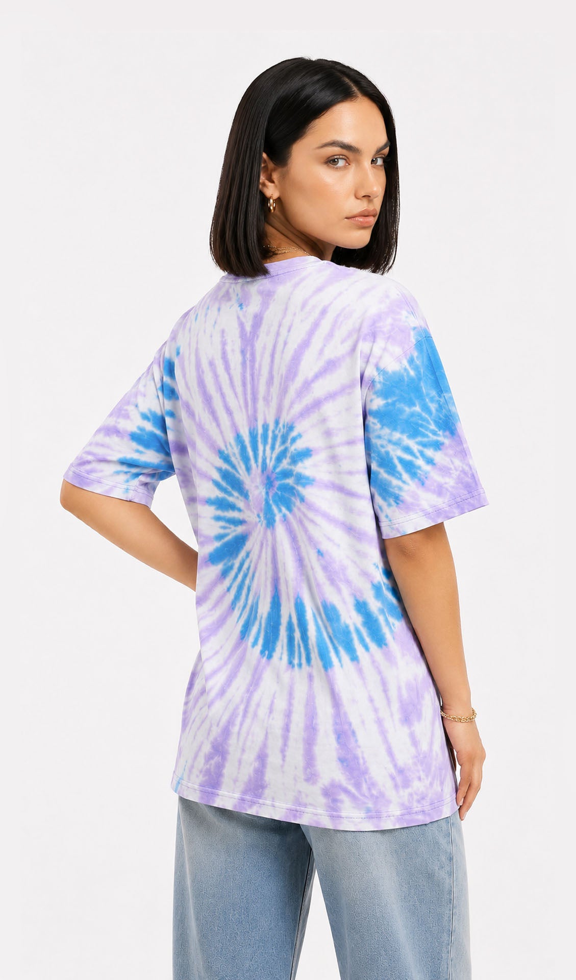 Woman wearing a tie-dye shirt with a white background.Slayink women Tie & dye tshirt, Slayink women t-Shirt,Oversized T-shirt, Oversized tie & dye T-shirt, oversized t-shirt, trendy college wear,casual wear, pastel top, women workout t-shirt,gym t-shirt women, ladies top, cotton t-shirt, trending top, baggy top, gym tee, loose tshirts for ladies, gym shirt , purple top, tie dye t-shirt women, Soft Girl Fashion, affordable  t-shirt, printed t-shirt women, college wear, t-shirt women.Purple tie & dye t-shirt,