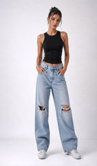 Woman wearing a black tank top and light blue jeans with rips on a white background.black tank top, black tank top women, women's black tank top, black sleeveless top, black camisole top, black vest top women, black summer top, basic black tank top, fitted black tank top, ribbed black tank top, casual black top, trendy black tank top, women's fashion top, black top for women, ladies black top, stylish black tank top, black crop tank top, everyday tank top, minimalist fashion, casual women's wear.