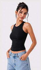Woman wearing a black tank top and light blue jeans against a white background.black tank top, black tank top women, women's black tank top, black sleeveless top, black camisole top, black vest top women, black summer top, basic black tank top, fitted black tank top, ribbed black tank top, casual black top, trendy black tank top, women's fashion top, black top for women, ladies black top, stylish black tank top, black crop tank top, everyday tank top, minimalist fashion, casual women's wear, summer fashion 