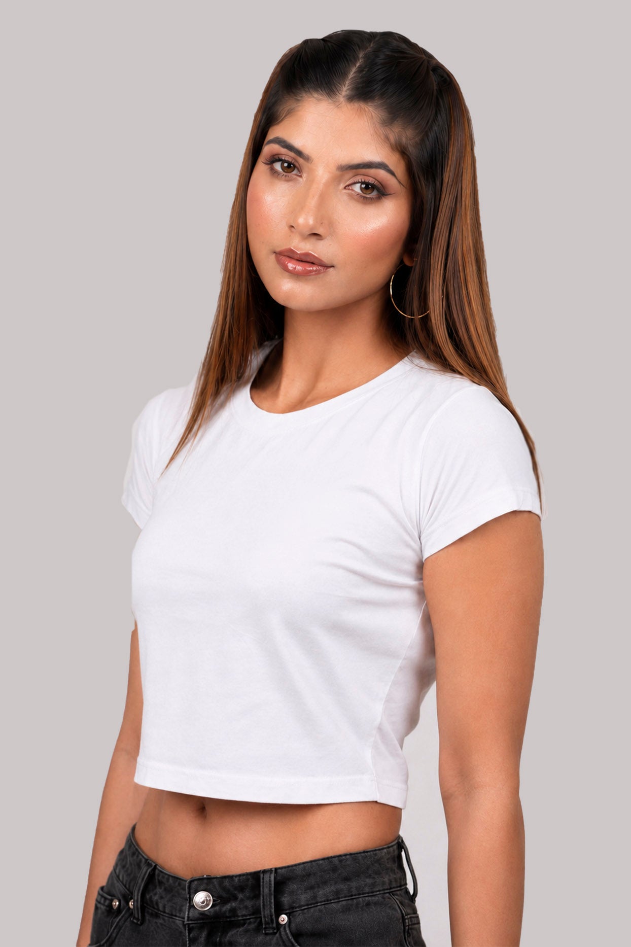 Woman wearing a white crop top against a plain background.white crop top, white crop top women, women's white crop top, white top for women, white cropped top, trendy white crop top, stylish white top, casual white crop top, summer crop top, fitted crop top, basic white crop top, sleeveless crop top, women's fashion top, ladies white top, fashion crop top, chic white crop top, minimalist fashion, aesthetic outfit, casual women's wear, trendy women's clothing, summer fashion women, everyday outfit.