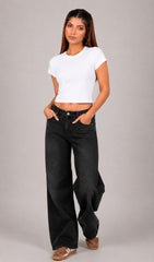 Woman wearing a white crop top and black jeans on a plain background.white crop top, white crop top women, women's white crop top, white top for women, white cropped top, trendy white crop top, stylish white top, casual white crop top, summer crop top, fitted crop top, basic white crop top, sleeveless crop top, women's fashion top, ladies white top, fashion crop top, chic white crop top, minimalist fashion, aesthetic outfit, casual women's wear, trendy women's clothing, summer fashion women, everyday outfit